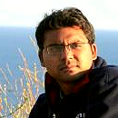 Portrait of Ashwin Naidu, seaside.