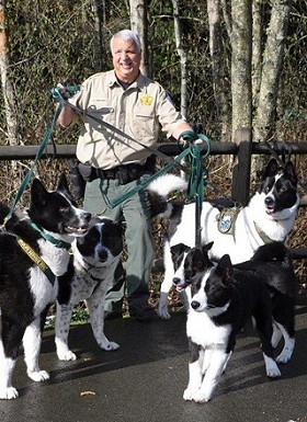 WDFW Captain Bill Hebner and the Department's 6 Karelian Bear Dogs.
